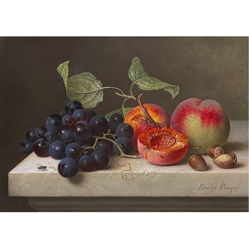 Still life with grapes, peaches and hazelnuts on a marble platter